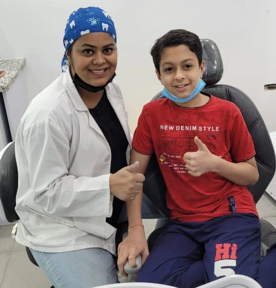 Doctor and child seated in a dental treatment room